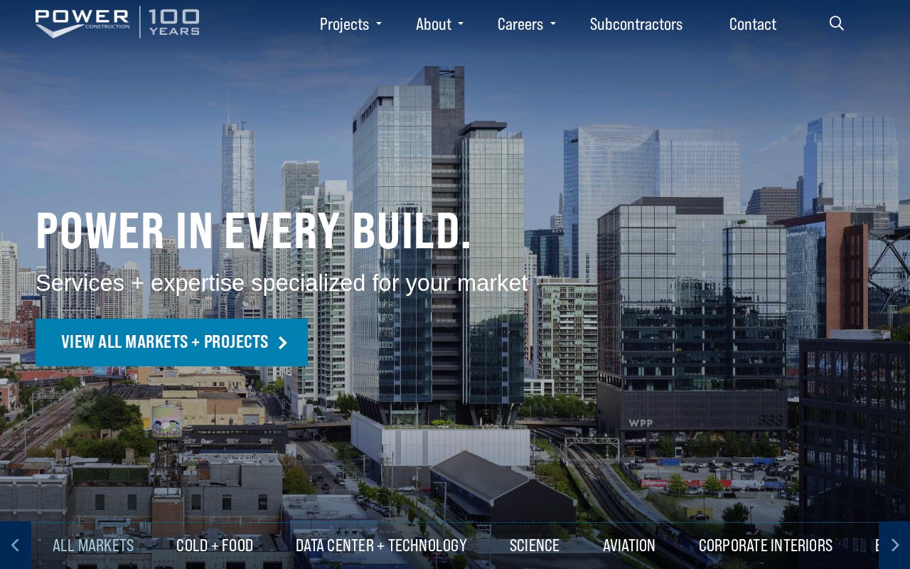 POWER Construction homepage with bold POWER IN EVERY BUILD tagline and 12 animated market sectors