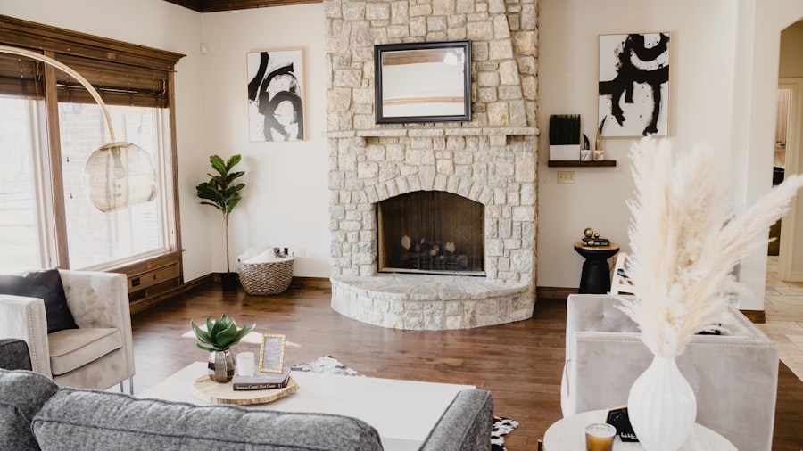 airy open-plan living room with a white stone fireplace and pampas grass in soft daylight
