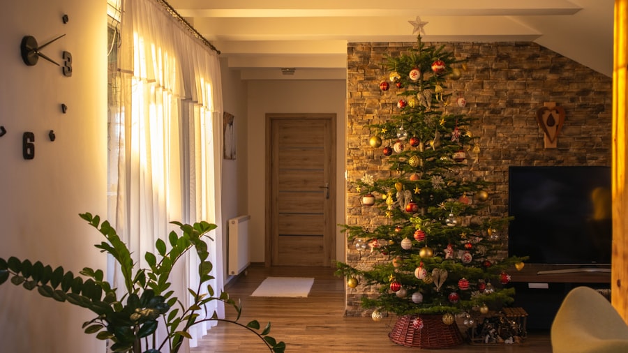 decorated Christmas tree against a rough stone wall with greenery and warm daylight