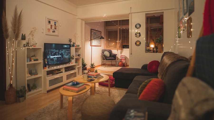 warm layered living room glowing with fairy lights, a low wooden coffee table, and a television on open shelving