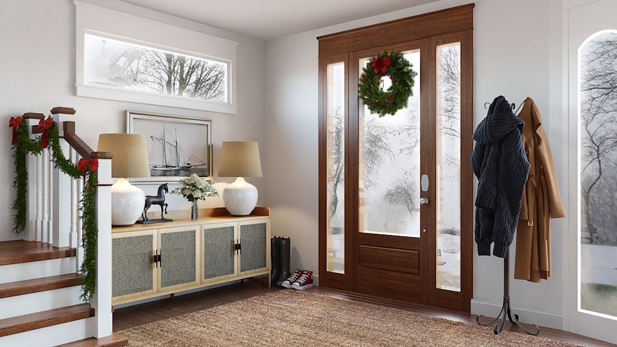 bright entryway with a wreath on a glass door and garland wound along the staircase