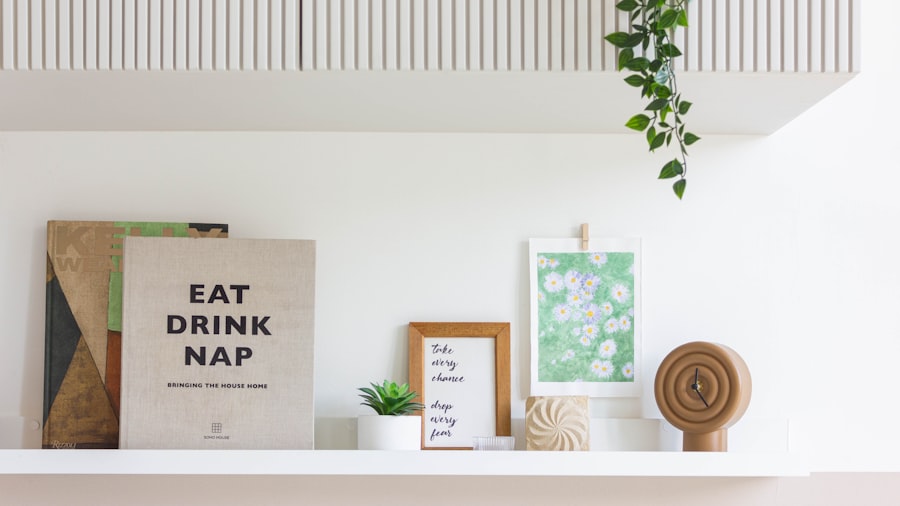 a styled white shelf with framed prints, trailing plants, and a small typographic sign