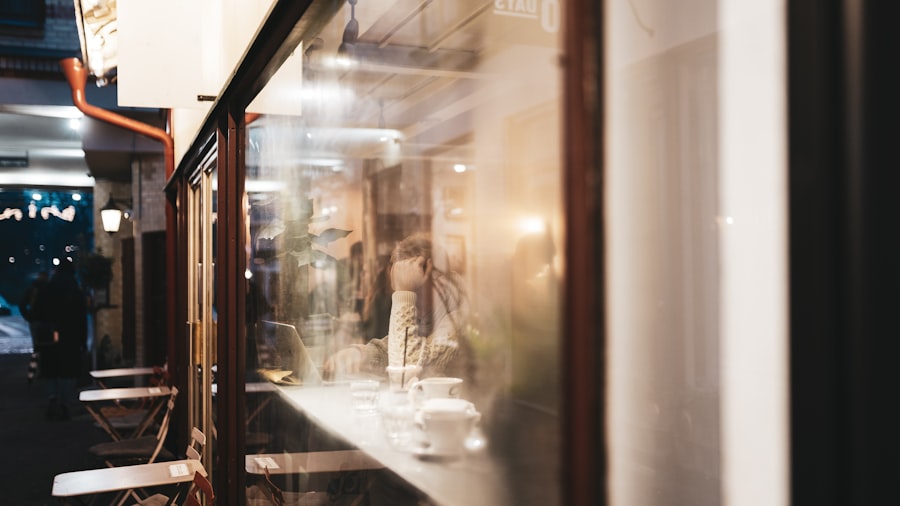 defocused café storefront at dusk with warm bokeh reflections in the glass