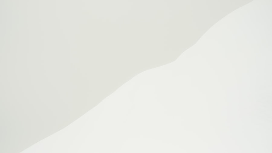 plain white wall lit by a soft diagonal shadow — clean and minimal