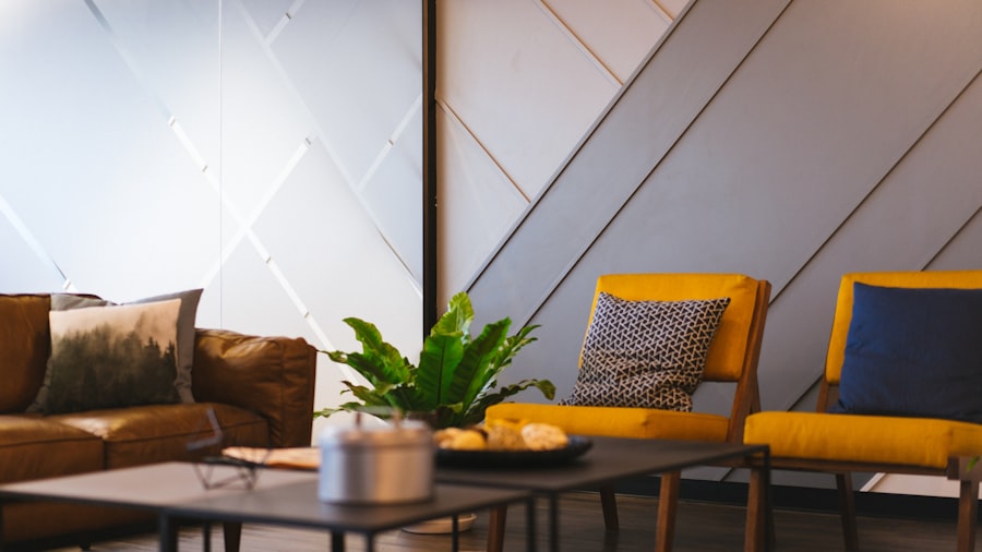 warm office lounge with mustard armchairs, a leafy plant, and an angular timber ceiling